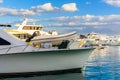 Closeup of white luxury yacht in a sea harbor of Hurghada, Egypt. Marina with tourist boats on Red Sea