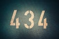 Closeup of white number 434 on a wall Royalty Free Stock Photo