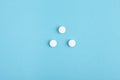 Closeup of white pills on a blue background. Heap of pills - medical background