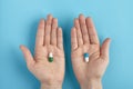 Closeup of white pills on a hands on a blue background. Heap of pills - medical background. Close up