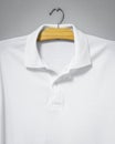 Closeup of White shirt hanging on cement wall. Blank t-shirt for printing Royalty Free Stock Photo