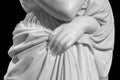 Closeup of white stone marble statue woman hand holding a tunic isolated on black background Royalty Free Stock Photo