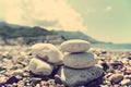 Closeup of white stones on the pebbly beach; filtered, faded, retro style