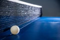 Closeup white table tennis ball and a black net Royalty Free Stock Photo