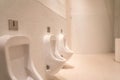 Closeup white urinals in men`s bathroom, design of white ceramic urinals for men in toilet room Royalty Free Stock Photo