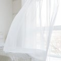 Closeup of white waving curtain in bedroom Royalty Free Stock Photo