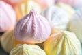 Closeup white, yellow and pink meringues . Sweet food background