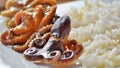 Closeup of whole baby octopuses served with rice. Royalty Free Stock Photo