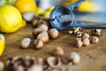 Closeup of whole and broken hazelnuts, lemon, walnut and nutcrackers on a wooden kitchen board. Health concept.