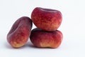 Closeup of whole flat peaches isolated on a white background