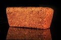 closeup whole rectangular rye bread with sesame seeds