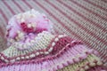 Closeup of wicker, winter, thick hat draped over the sofa. Ashes