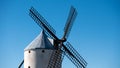 Closeup of the Windmill of Campo de Criptana under the sunlight and a blue sky in Spain