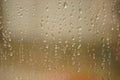 Closeup window glass in rain drops. Blurred background