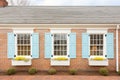 closeup of windows with shutters on brick cape cod house Royalty Free Stock Photo