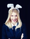 Closeup of winking bunny girl face. Blonde woman in rabbit bunny ears. Sweet lovely attractive adorable charming