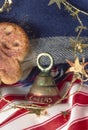 Closeup winter holiday celebration with Cheers on the bell, stars and gingerbread cookie. Background is a blue wool scarf and red