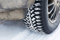 Closeup winter wheel with iron spikes for mud and snow terrain Royalty Free Stock Photo