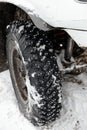 Closeup winter wheel with iron spikes for mud and snow terrain Royalty Free Stock Photo