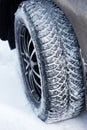Closeup winter wheel with iron spikes for mud and snow terrain. Royalty Free Stock Photo