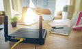 Closeup of a wireless router and a man using smartphone on living room at home ofiice Royalty Free Stock Photo