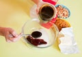 Closeup of woman adds honey into dish