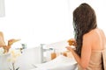 Closeup on woman applying hair mask in bathroom Royalty Free Stock Photo