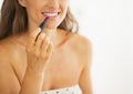 Closeup on woman applying lipstick in bathroom Royalty Free Stock Photo