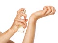 Closeup on woman applying perfume on hand