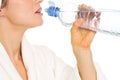 Closeup on woman in bathrobe drinking water Royalty Free Stock Photo