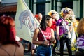 Closeup woman carries flag with group emblem by city street at dominican carnival