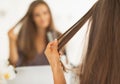 Closeup on woman checking hair after straightening