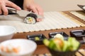 Closeup of woman chef cutting japanese sushi roll Royalty Free Stock Photo