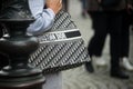 Closeup of woman with a Christian Dior hand bag standing in the street