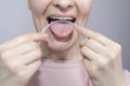 Closeup Of Woman Cleaning Her Tongue With Plastic Flexible Tongue Scraper, Cleaner
