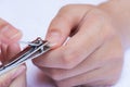 Closeup of a woman cutting nails