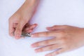 Closeup of a woman cutting nails