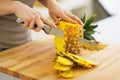 Closeup on woman cutting pineapple Royalty Free Stock Photo