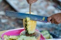 Closeup on woman cutting pineapple.Sold in the market.