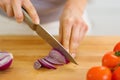 Closeup on woman cutting red onion Royalty Free Stock Photo