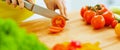 Closeup on woman cutting tomato in kitchen Royalty Free Stock Photo