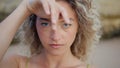 Closeup woman dancer moving hands smoothly on sand beach. Curly young performer Royalty Free Stock Photo