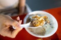 Closeup of a woman eating porridge with a chinese spoon at Liuhe Night Market, Kaohsiung, Taiwan Royalty Free Stock Photo