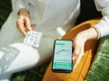 Woman buying pharma using phone in house in sunny day