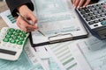 closeup woman filling 1040 tax form at office