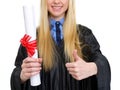 Closeup on woman in graduation gown showing diploma Royalty Free Stock Photo