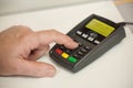 Woman hand on credit card terminal un store