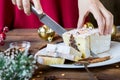 Woman hand cut christmas chocolate cake with holiday decoration. Food xmas background. Royalty Free Stock Photo