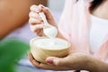 woman hand eating yogurt hand holding wooden spoon and bowl of yogurts Royalty Free Stock Photo