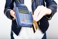 Closeup woman hand holding credit card over payment terminal Royalty Free Stock Photo